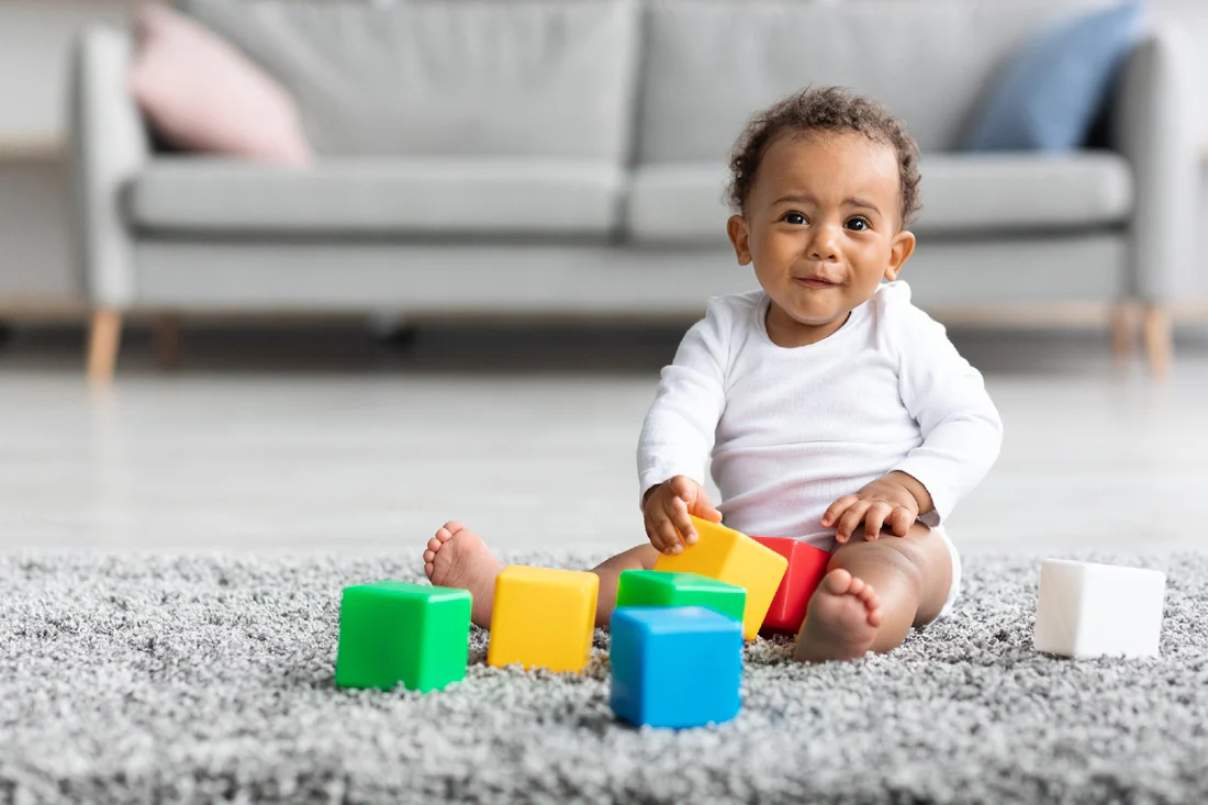 Child contentedly playing alone in a minimalist bedroom